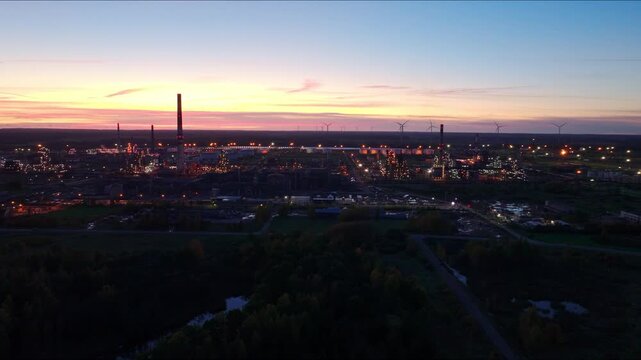 Drone slides left above Orlen Lietuva oil refinery in Juodeikiai sunset