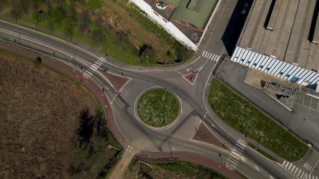 Empty roundabout in an industrial zone in Italy. Infrastructure layout showing road network design and logistics access in a modern urban industrial area.