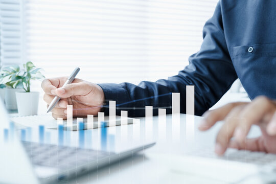 Business professional using calculator, laptop, financial charts and take important note, represents financial analysis, accounting systems, budgeting, reporting, performance tracking, ERP integration