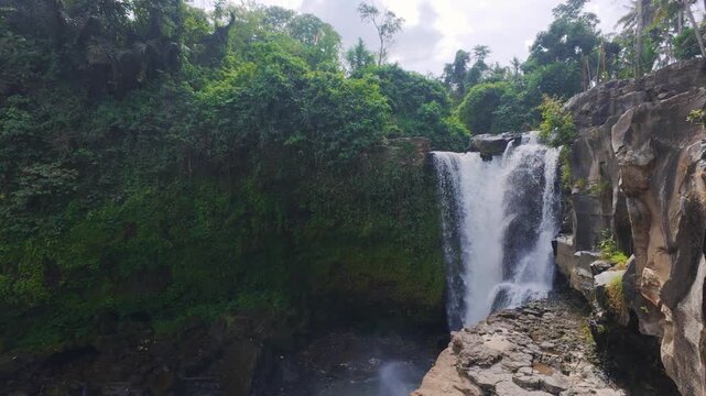 Beautiful dramatic Tegenungan Waterfall aka Blangsinga Waterfall flowing from Petanu River on the island of Bali, Indonesia