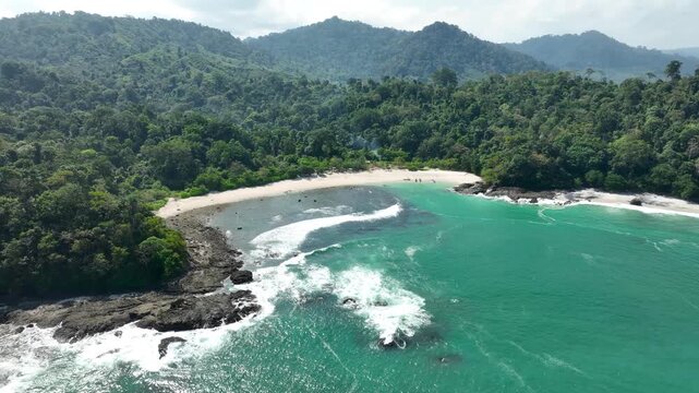 Aerial Pan Tropical Wedi Ireng Beach Hidden Cove Crystal Water And Dense Jungle East Java Indonesia