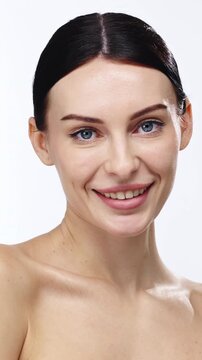 Female beauty portrait with healthy youthful skin on clean background. Concept cosmetology procedures and skincare lifestyle.

