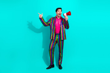 Fototapeta premium Vibrant retro showman in rainbow suit with megaphone inviting a party audience and celebrating a colorful performance