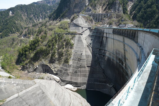 High angle view of the massive arch structure at Kurobe Dam.