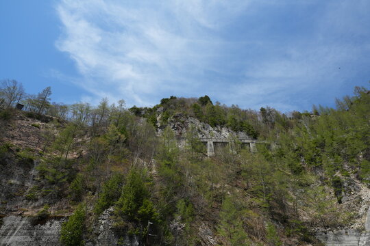 A low angle view of steep green mountains under blue sky.