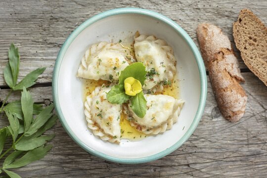 Carinthian noodles filled with herbs and cream cheese, melted butter, bread and lovage, Irschen, Carinthia, Austria