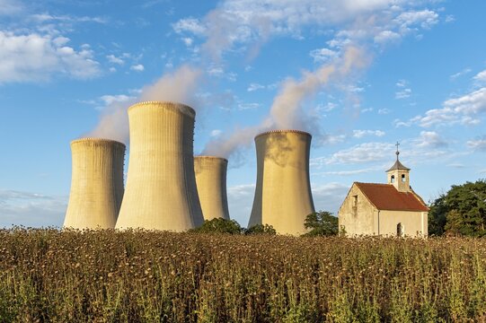 Old abandoned chapel and cooling towers of Dukovany Nuclear Power Station, Czech Republic