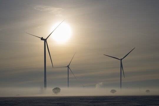 Wind turbines stand in fog under a dramatic sky at sunset, wind turbines between Solschen and Adenstedt, Ilsede, Peine district, Lower Saxony, Germany