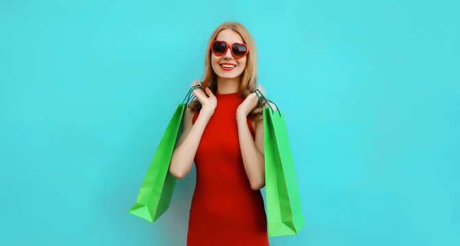 Fashion, clothing. Stylish beautiful happy woman with colorful shopping bags in vivid outfit