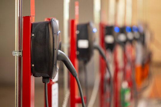 EV charging and electric car, Electric car charging station for charge EV battery, Plug for vehicle with electric engine, EV charger clean energy, Charging point at car parking lot.