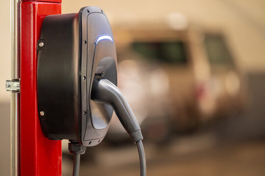 EV charging and electric car, Electric car charging station for charge EV battery, Plug for vehicle with electric engine, EV charger clean energy, Charging point at car parking lot.