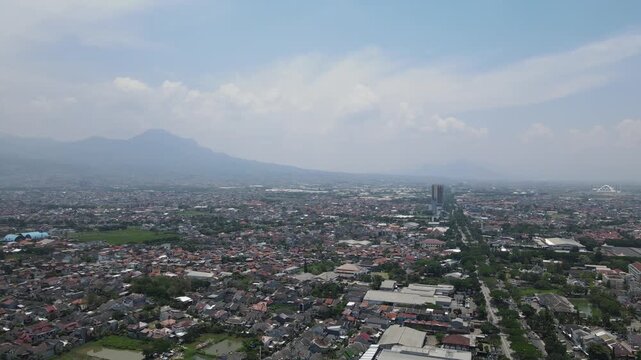 Beautiful aerial landscape of street soekarno-hatta bandung city skyline with mountain view under clear blue sky
