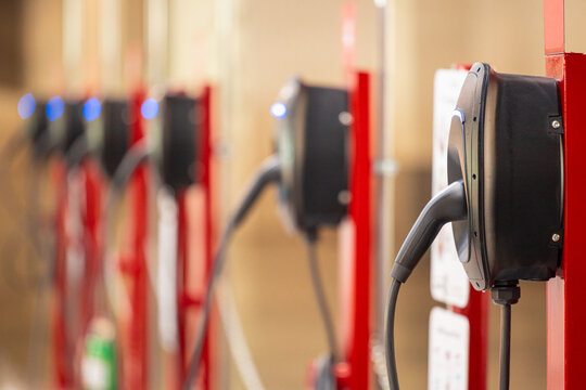 EV charging and electric car, Electric car charging station for charge EV battery, Plug for vehicle with electric engine, EV charger clean energy, Charging point at car parking lot.