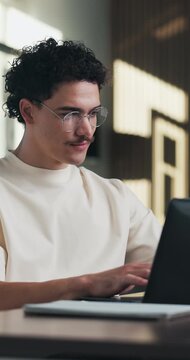 Creative, man and typing on laptop in office for research, editing draft and fact checking. Editor, person and tech at agency for article feedback, proofreading or grammar review of story publication