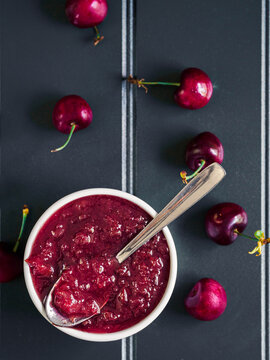 tablespoon of homemade cherry jam with a juicy texture, top view