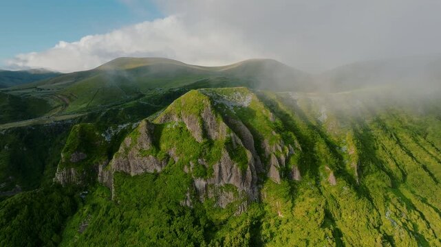 Majestic and Towering Volcanic Ridges Draped in Lush Verdant Greenery, Bathed in Soft Diffused Sunlight and Floating Clouds, Flores Island, Azores