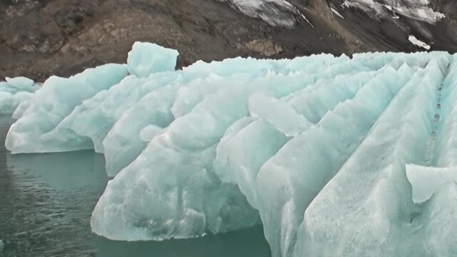 Massive blue ice floes glide across the tranquil Arctic Ocean. This stunning display of nature's power marks a breathtaking part of an extreme polar travel expedition.
