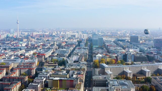 4K aerial view of Berlin Mitte with Fernsehturm TV tower, Berliner Dom, Gendarmenmarkt domes and the Die Welt balloon over Leipziger Strasse.
