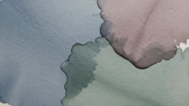 Abstract watercolor paint spreads across textured paper. Organic shapes blend and overlap in muted tones.