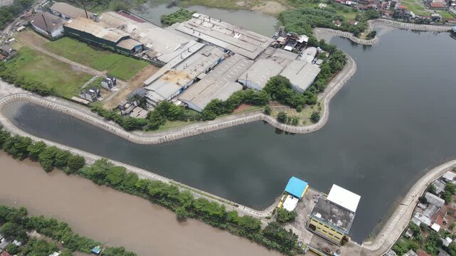 Drone shot of a large city lake next to dense neighborhood housing area