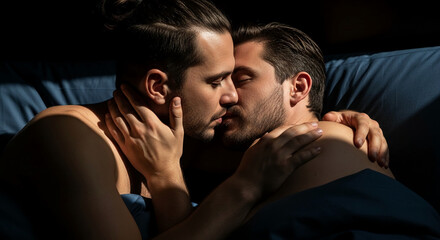 Obraz premium Intimate close-up of two men embracing, with soft light highlighting their faces and touching hands, symbolizing love, connection, and passion, evoking a sense of deep emotional bond