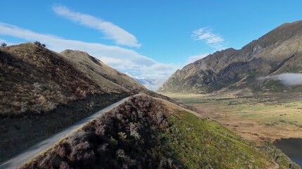 Fototapeta premium Aerial View of a Winding Mountain Road Through Queenstown Valley