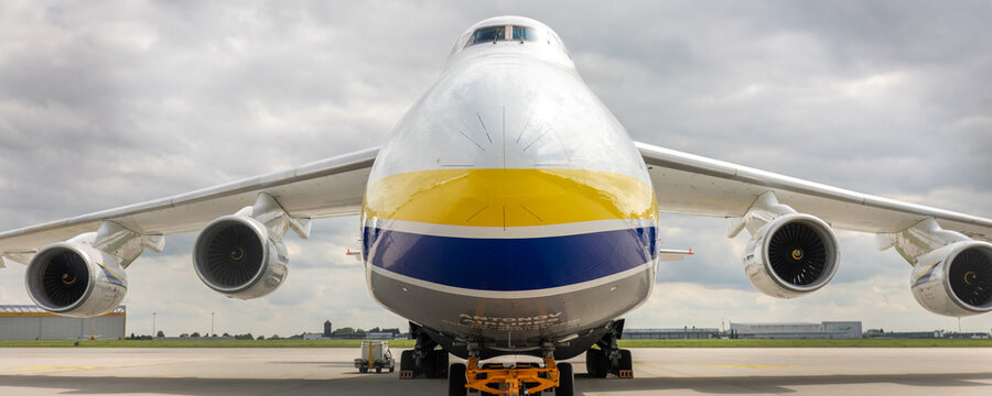 Schkeuditz, Germany - 9 May, 2026.Front massive Antonov AN-124 Ruslan cargo aircraft parked on airport apron under dramatic cloudy sky