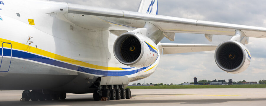 Schkeuditz, Germany - 9 May, 2026.Front massive Antonov AN-124 Ruslan cargo aircraft parked on airport apron under dramatic cloudy sky