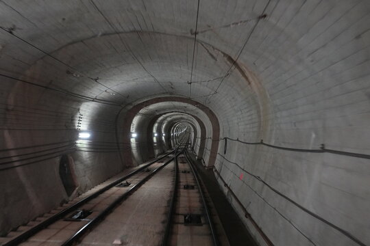 Deep perspective of a concrete cable car tunnel in Japan.