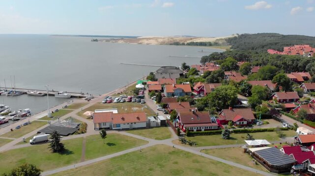 An aerial shot captures the charming coastal resort town of Nida in the Neringa region of Lithuania