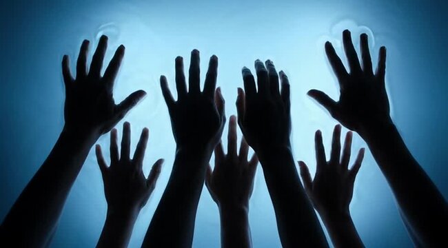 Silhouette of hands reaching upward from underwater against blue light, representing struggle, unity, hope, aspiration, connection, surrender, and human emotion