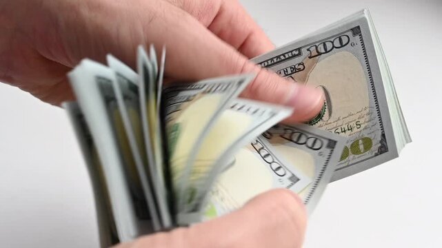 Hands counting stack of one hundred dollar bills in motion, financial concept footage.