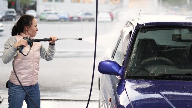 Watch the transformation as a woman carefully washes her blue car. The routine provides a sense of satisfaction and pride, underscoring the joy of taking care of your prized possession.
