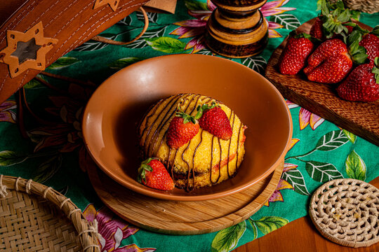 Traditional Sweet Brazilian Couscous with Chocolate Drizzle and Fresh Strawberries