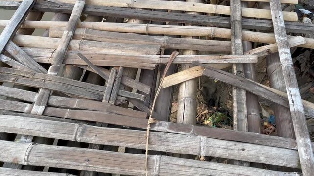 Close up of broken and damaged wooden footbridge structure