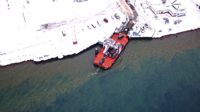 Cinematic overhead drone shot of a ferry operating between Sugar Island and Michigan&rsquo;s Upper Peninsula.