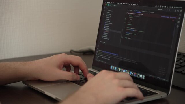 4K Close-Up of Software Developer Writing Code on Laptop in IDE
