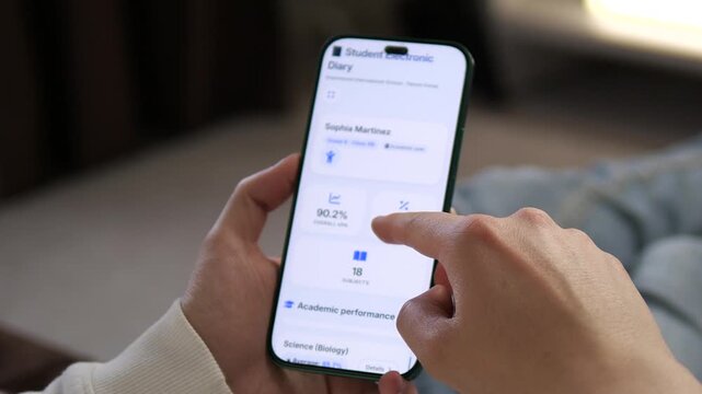 Viewing a students academic dashboard on a smartphone. The screen displays student overall GPA and attendance rate. Perfect for parent portals, school apps, and educational technology visuals.