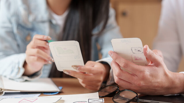 Designers collaborating on mobile application prototyping and user experience