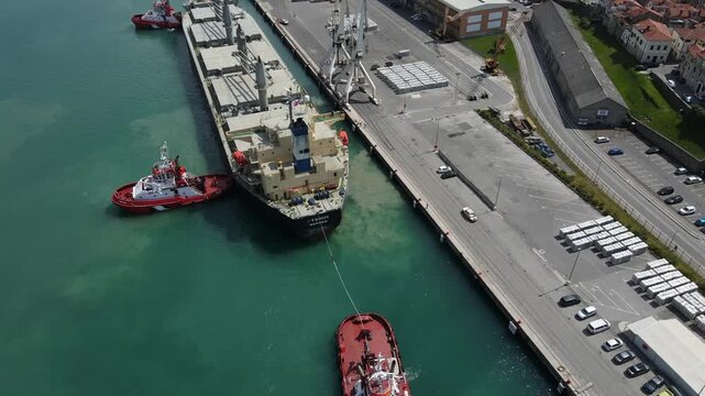 Tugboats guide tanker into Koper harbor with wide reveal
