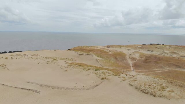 Aerial panoramic view of the Parnidis Dune and the Baltic Sea coastline near the resort town of Nida on the Curonian Spit, Lithuania.