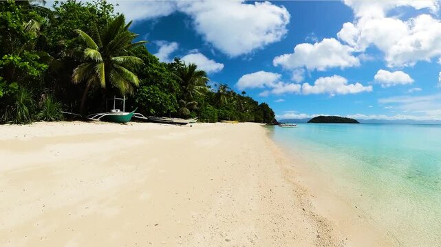 Coconut trees, boats on the sands and clear water in Tiamban Beach. Romblon Island. Philippines.