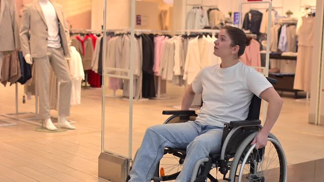 A Caucasian woman in a wheelchair shopping at a mall. 