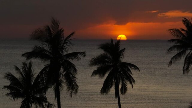 Beautiful glowing Sunset background in tropical beach with serene sea and coconut trees. Santa Fe, Tablas, Romblon. Philippines.