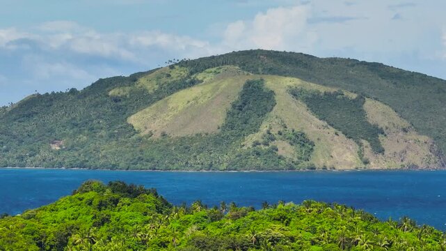 Mountain hill and tropical blues sea. Santa Fe, Tablas, Romblon, Philippines.