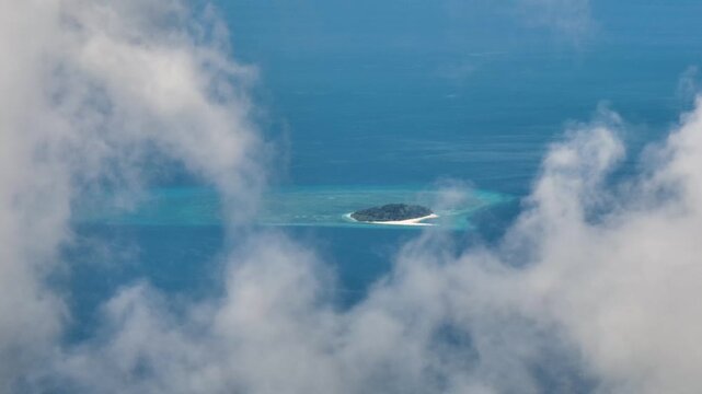 Clouds over Mantigue Island. White sandy beach and blue sea. Camiguin, Philippines.