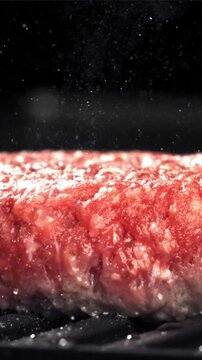 A beef burger is fried in a pan. Filmed on a high-speed camera at 1000 fps. High quality FullHD footage