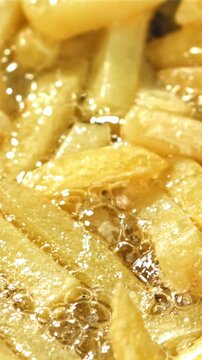 French fries are deep-fried in oil. Filmed on a high-speed camera at 1000 fps. High quality FullHD footage