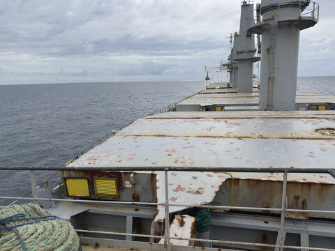 cargo ship view from forward. hatch and ventilation covers, hydraulic jack, cranes, superstructure
