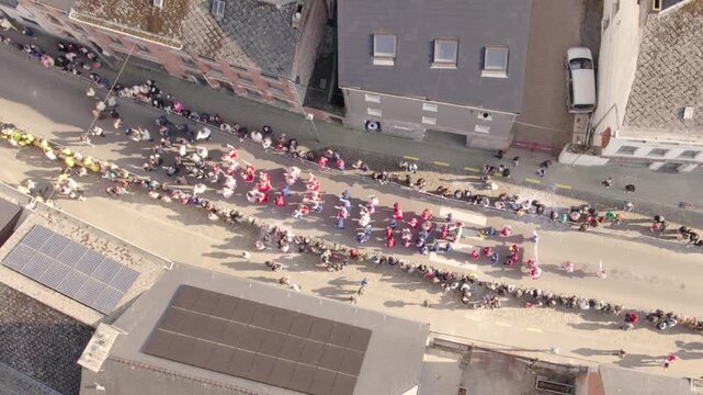 UNESCO Gille Carnival Performers Dancing In Belgian Village Street With Crowd, Aerial Drone Shot
